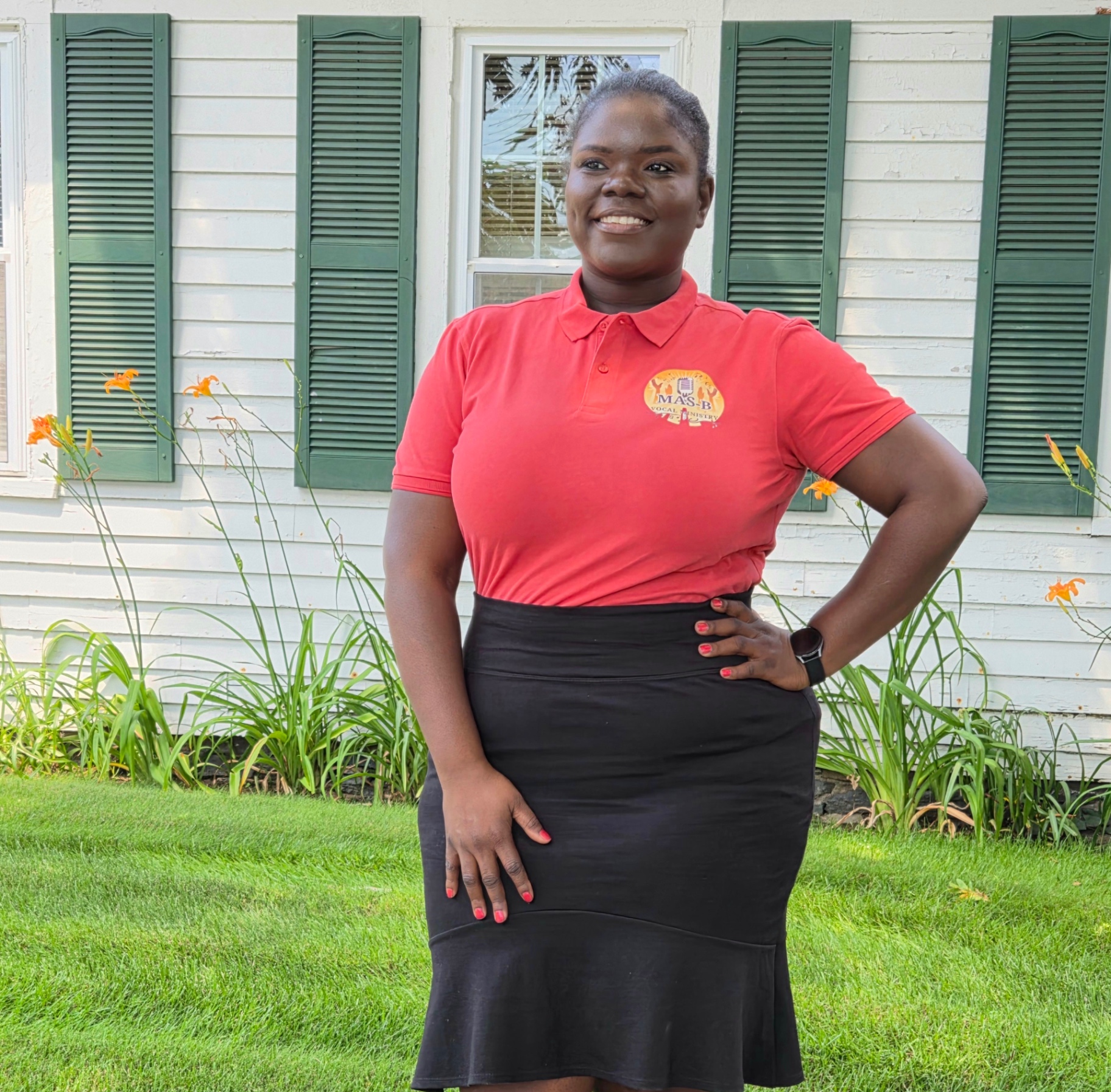 Smiling MAS-B Vocal Ministry member in the red ministry polo